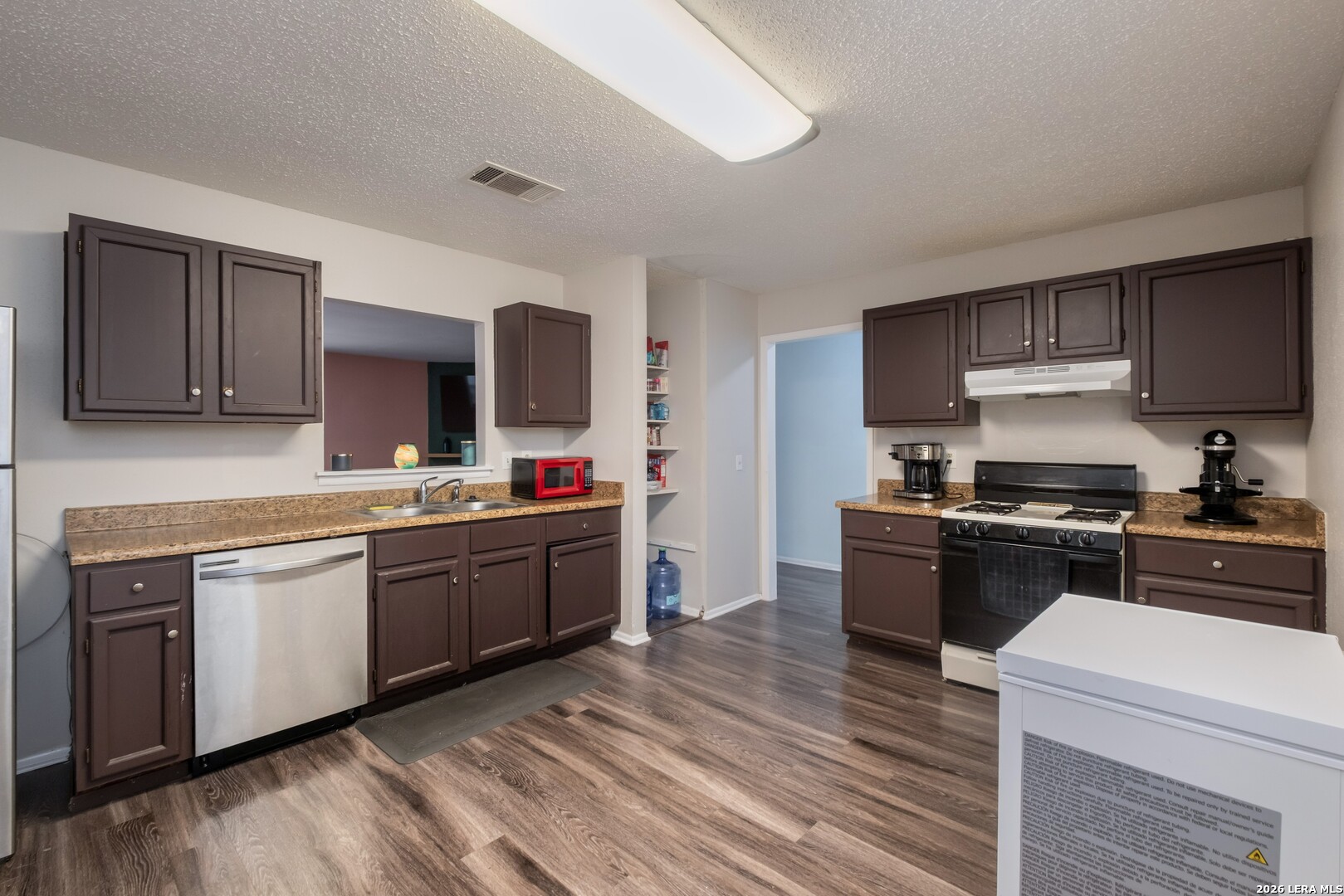 113 Friendswood Path Universal City, TX 78148 - Photo 5 of 30 a kitchen with stainless steel appliances granite countertop a sink stove and refrigerator