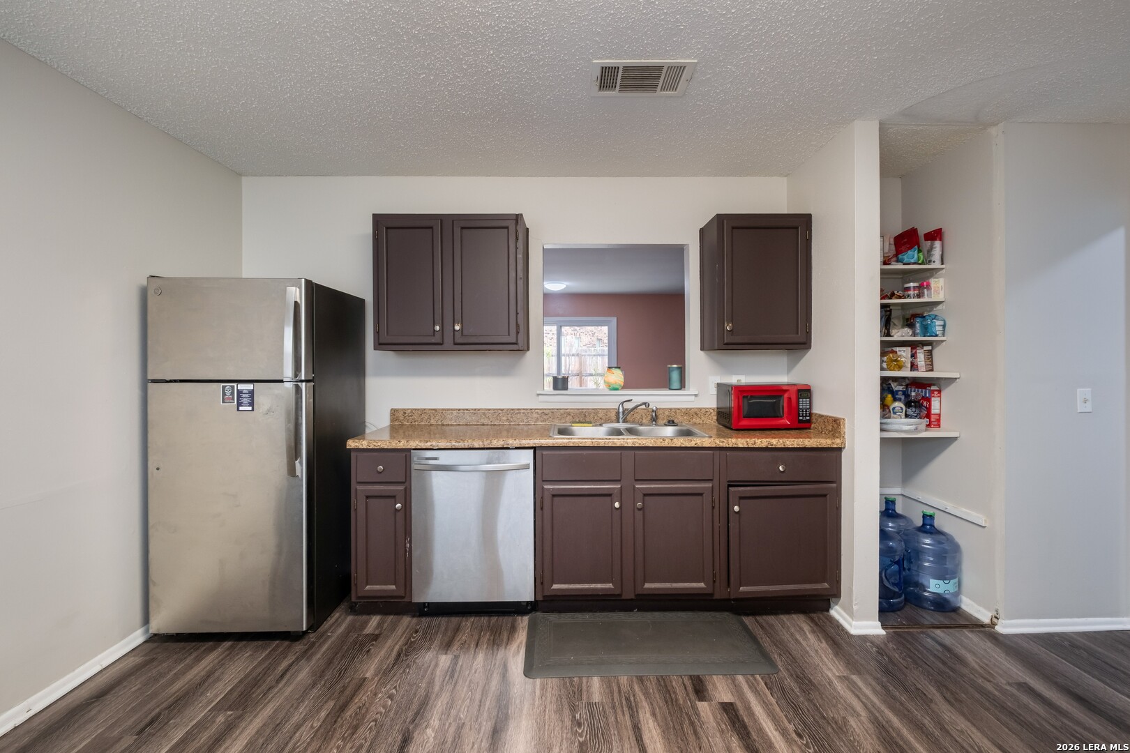 113 Friendswood Path Universal City, TX 78148 - Photo 7 of 30 a kitchen with stainless steel appliances granite countertop a refrigerator and a stove top oven