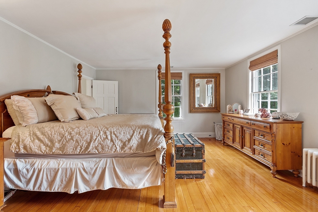251 A Old Billerica Road Bedford, MA 01730 - Photo 20 of 36 a bedroom with a bed and wooden floor