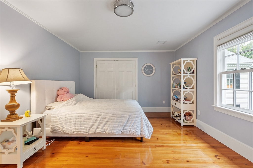 251 A Old Billerica Road Bedford, MA 01730 - Photo 23 of 36 a bedroom with a bed and wooden floor