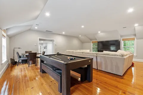 a kitchen with stainless steel appliances granite countertop a stove and a wooden floors
