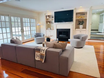 a living room with furniture fireplace and flat screen tv