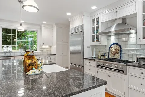 a kitchen with stove and cabinets