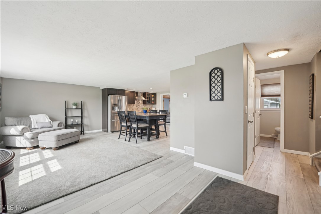 15415 Mason Road Vermilion, OH 44089 - Photo 6 of 50 Living area featuring light wood finished floors, baseboards, and visible vents