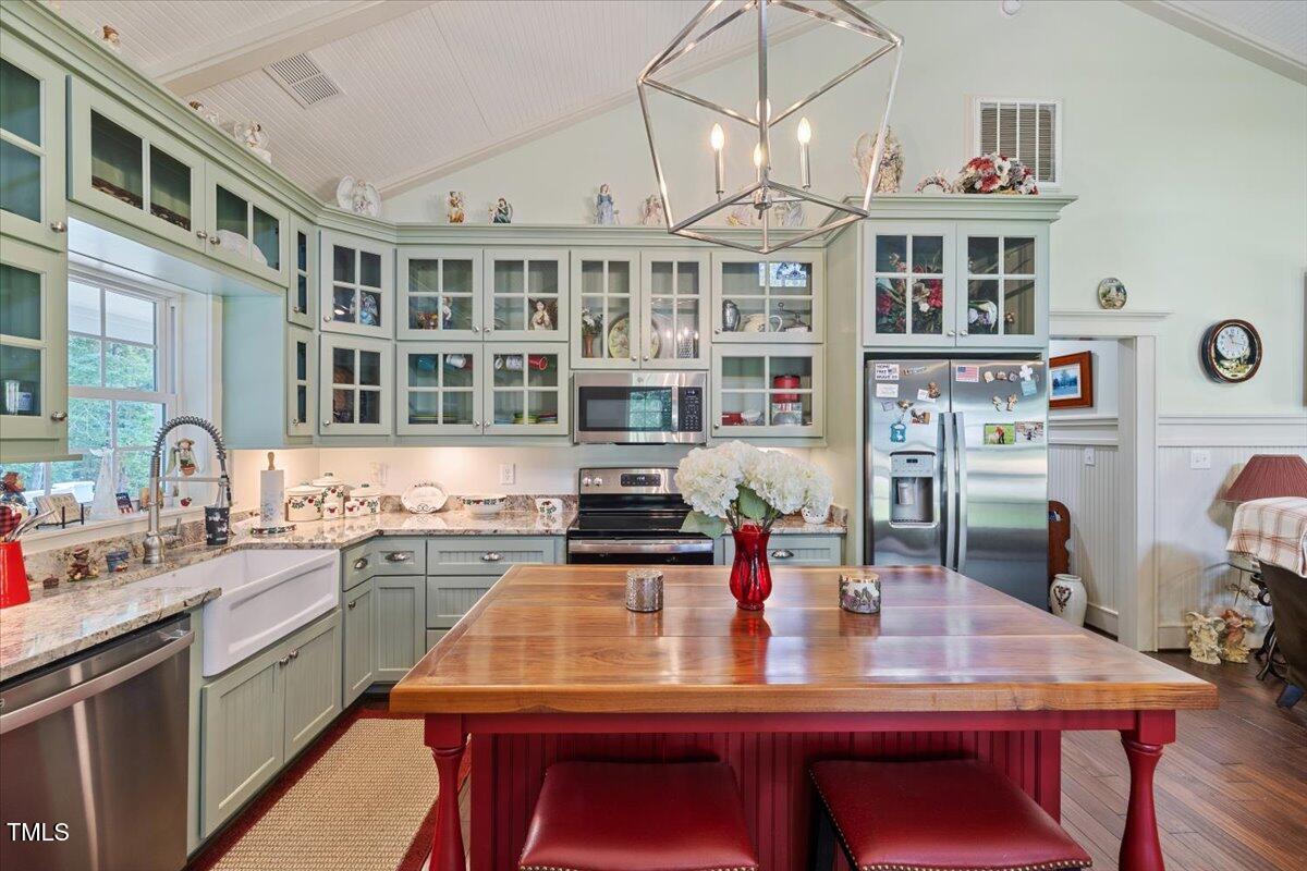 468 Loftis Loop Roxboro, NC 27574 - Photo 13 of 35 a kitchen with stainless steel appliances a dining table and chairs