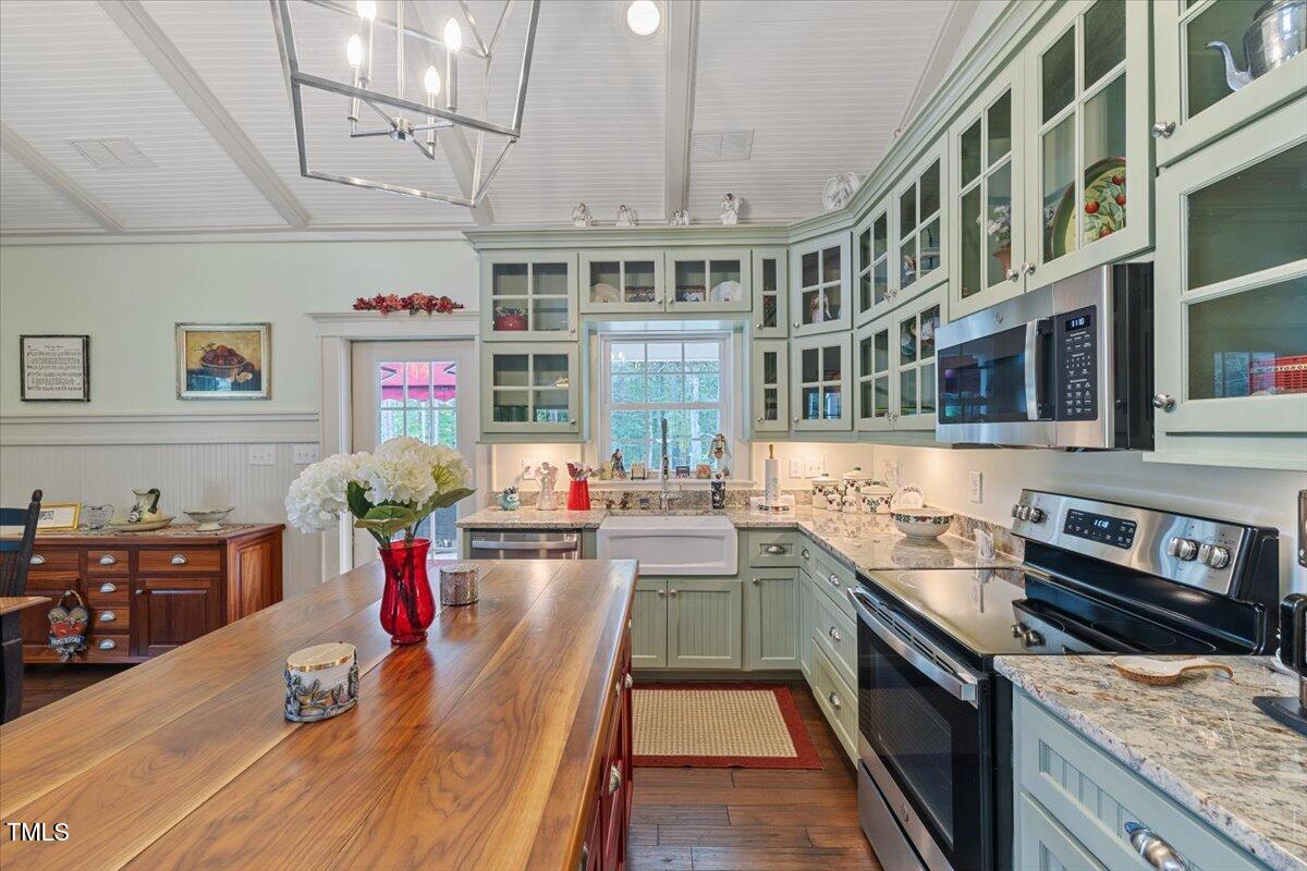 468 Loftis Loop Roxboro, NC 27574 - Photo 15 of 35 a kitchen with granite countertop lots of clutter and stainless steel appliances