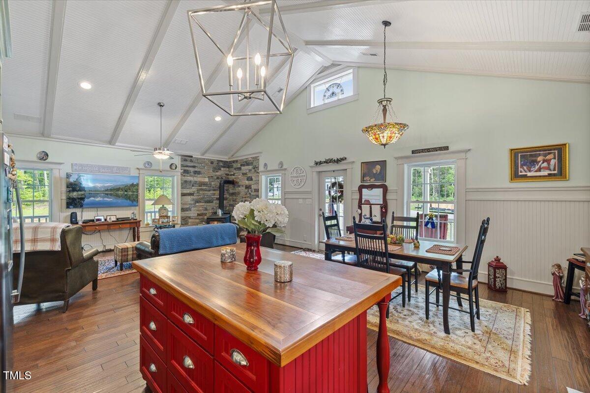 468 Loftis Loop Roxboro, NC 27574 - Photo 16 of 35 a view of a dining room with furniture a chandelier and wooden floor