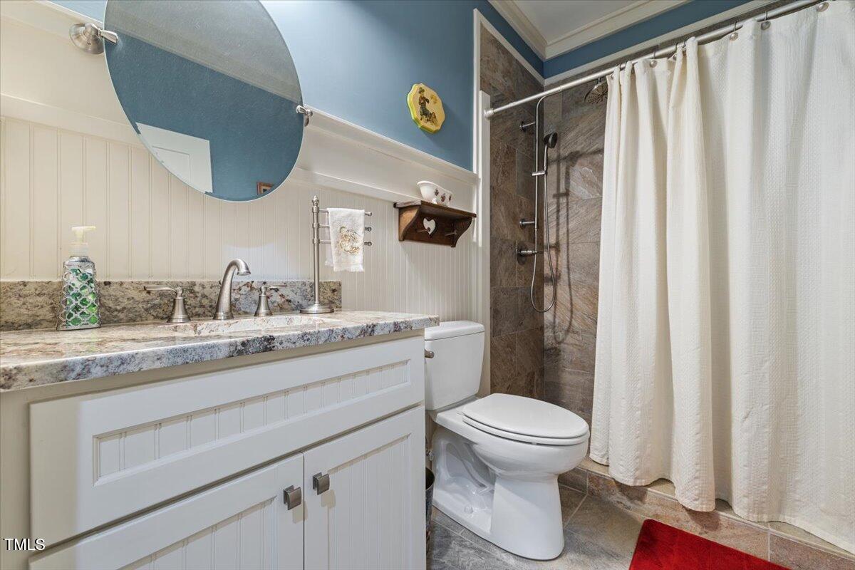 468 Loftis Loop Roxboro, NC 27574 - Photo 20 of 35 a bathroom with a granite countertop sink toilet a mirror and shower