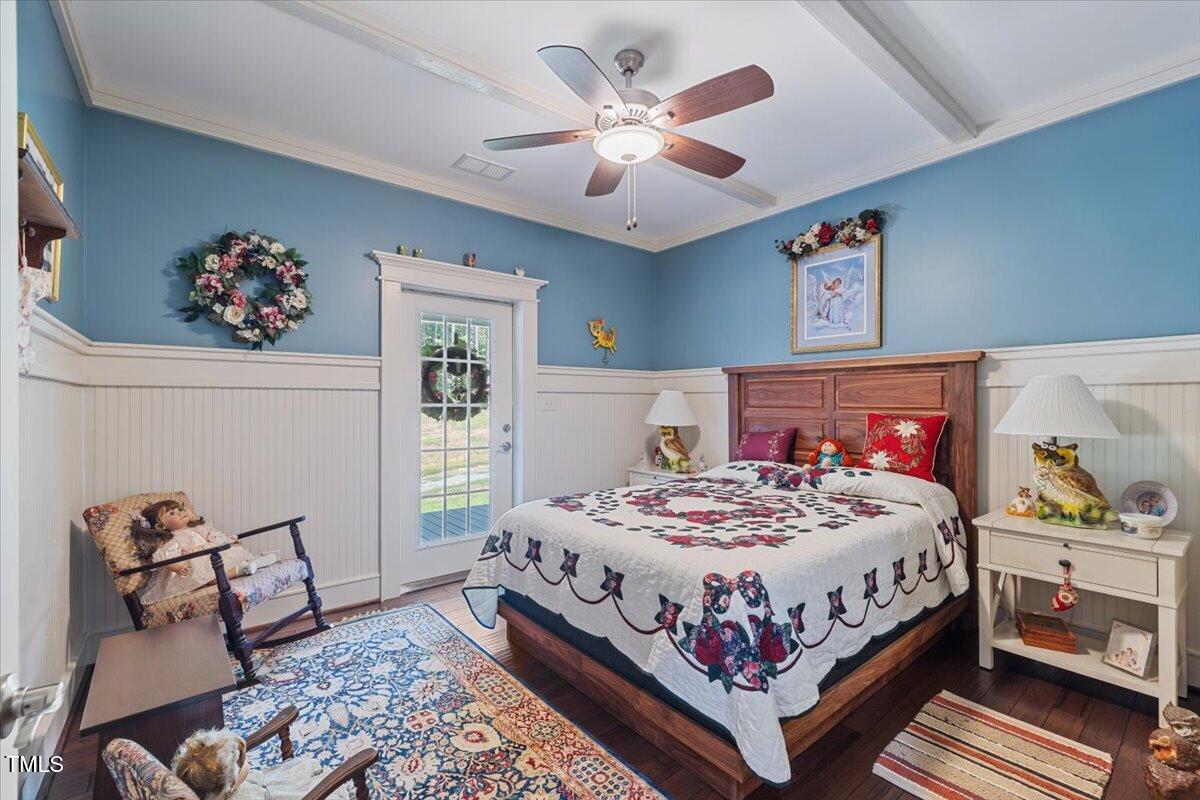 468 Loftis Loop Roxboro, NC 27574 - Photo 21 of 35 a bedroom with a bed and a chandelier