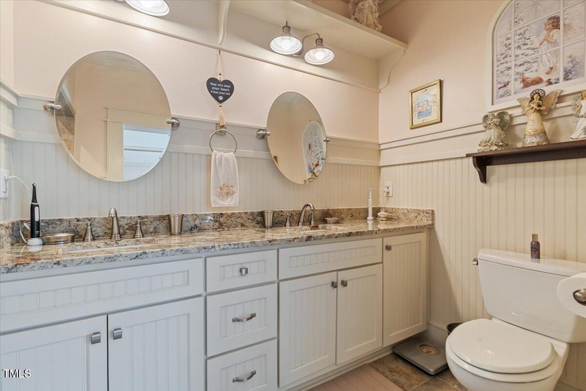 468 Loftis Loop Roxboro, NC 27574 - Photo 27 of 35 a bathroom with a granite countertop toilet sink and mirror