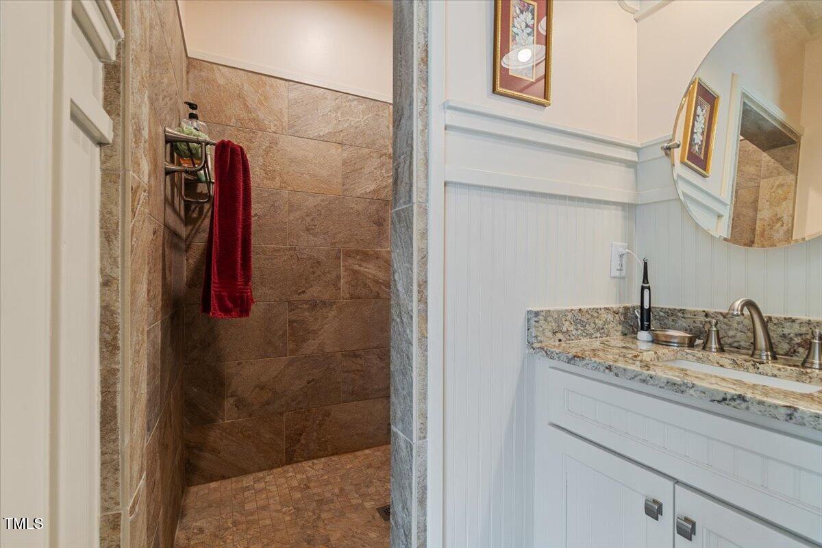 468 Loftis Loop Roxboro, NC 27574 - Photo 28 of 35 a bathroom with a granite countertop shower sink and vanity