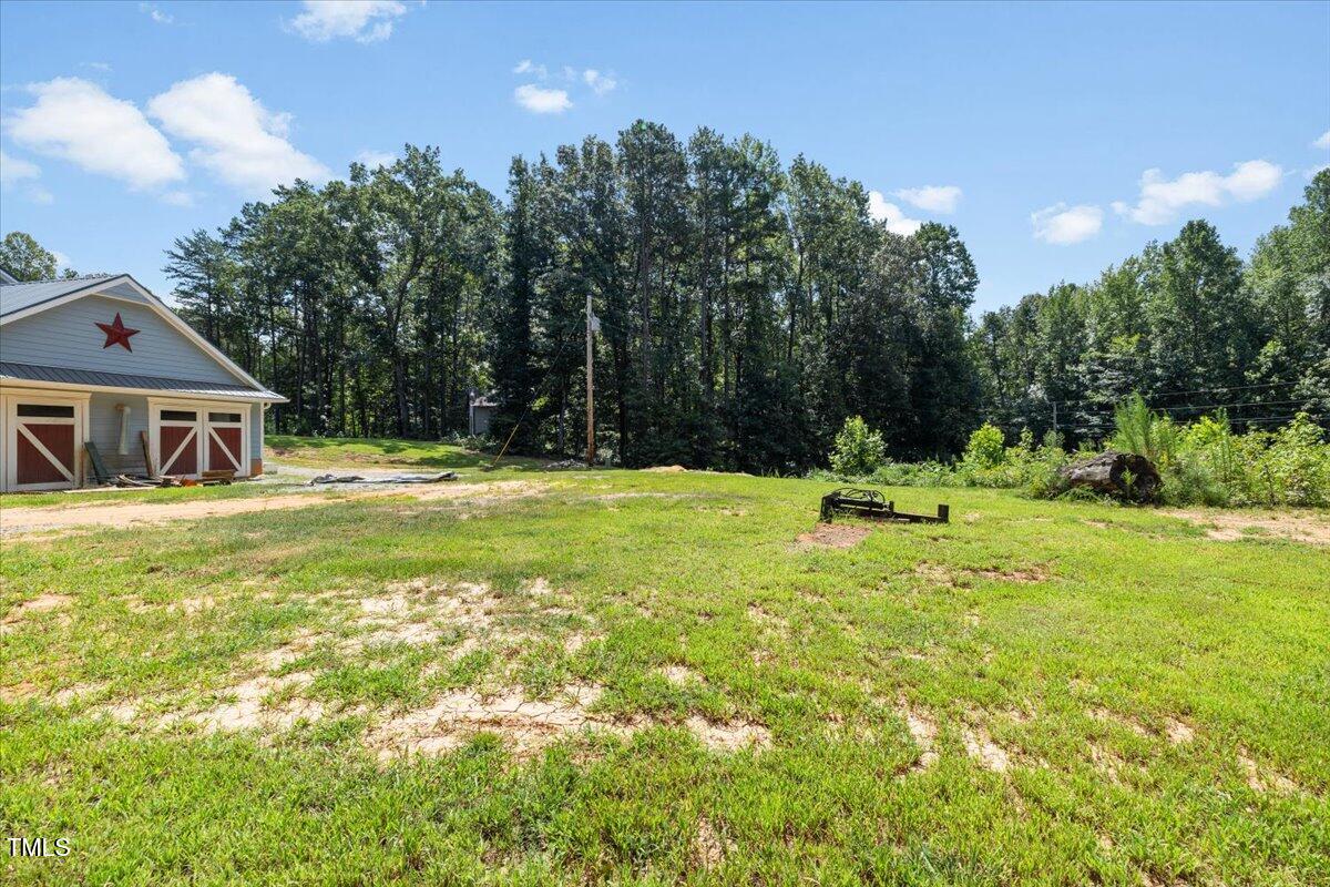 468 Loftis Loop Roxboro, NC 27574 - Photo 33 of 35 a view of a house with a big yard and large trees
