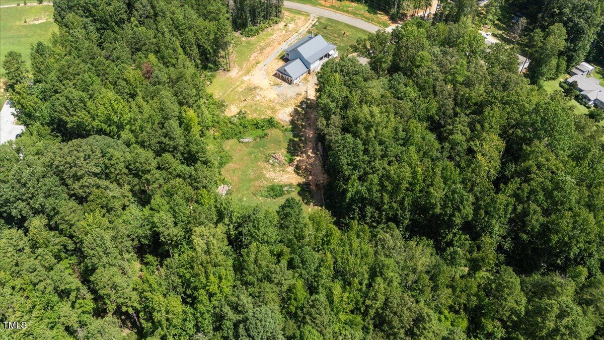 468 Loftis Loop Roxboro, NC 27574 - Photo 34 of 35 a view of a house with a lush green forest