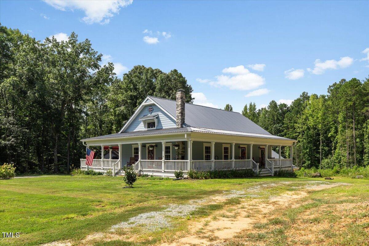 468 Loftis Loop Roxboro, NC 27574 - Photo 4 of 35 a front view of a house with a garden
