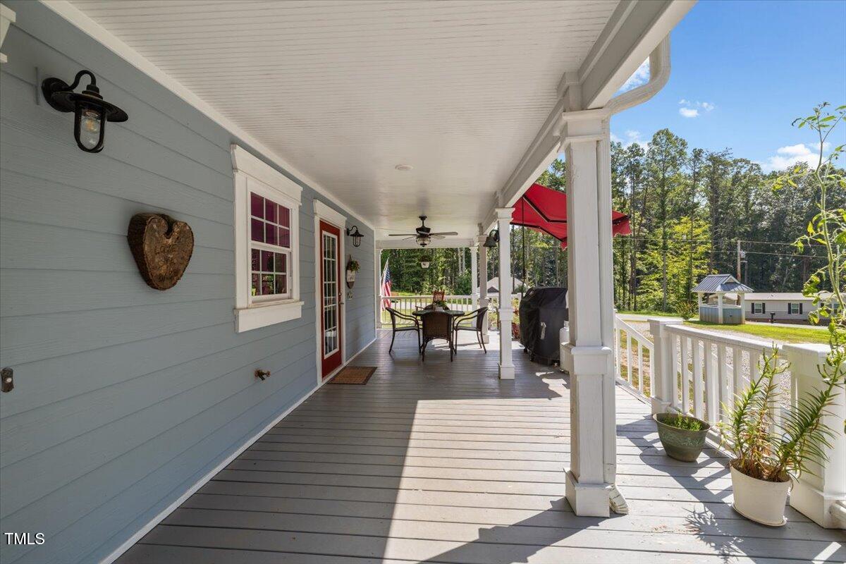 468 Loftis Loop Roxboro, NC 27574 - Photo 7 of 35 a view of a patio with couches potted plants and wooden floor
