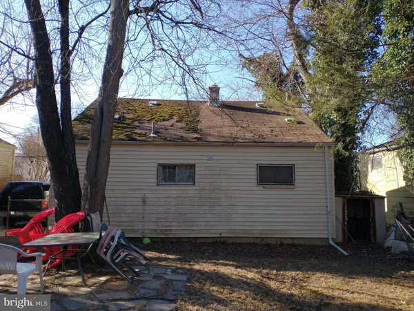 a view of a backyard with a table and chairs and a fire pit