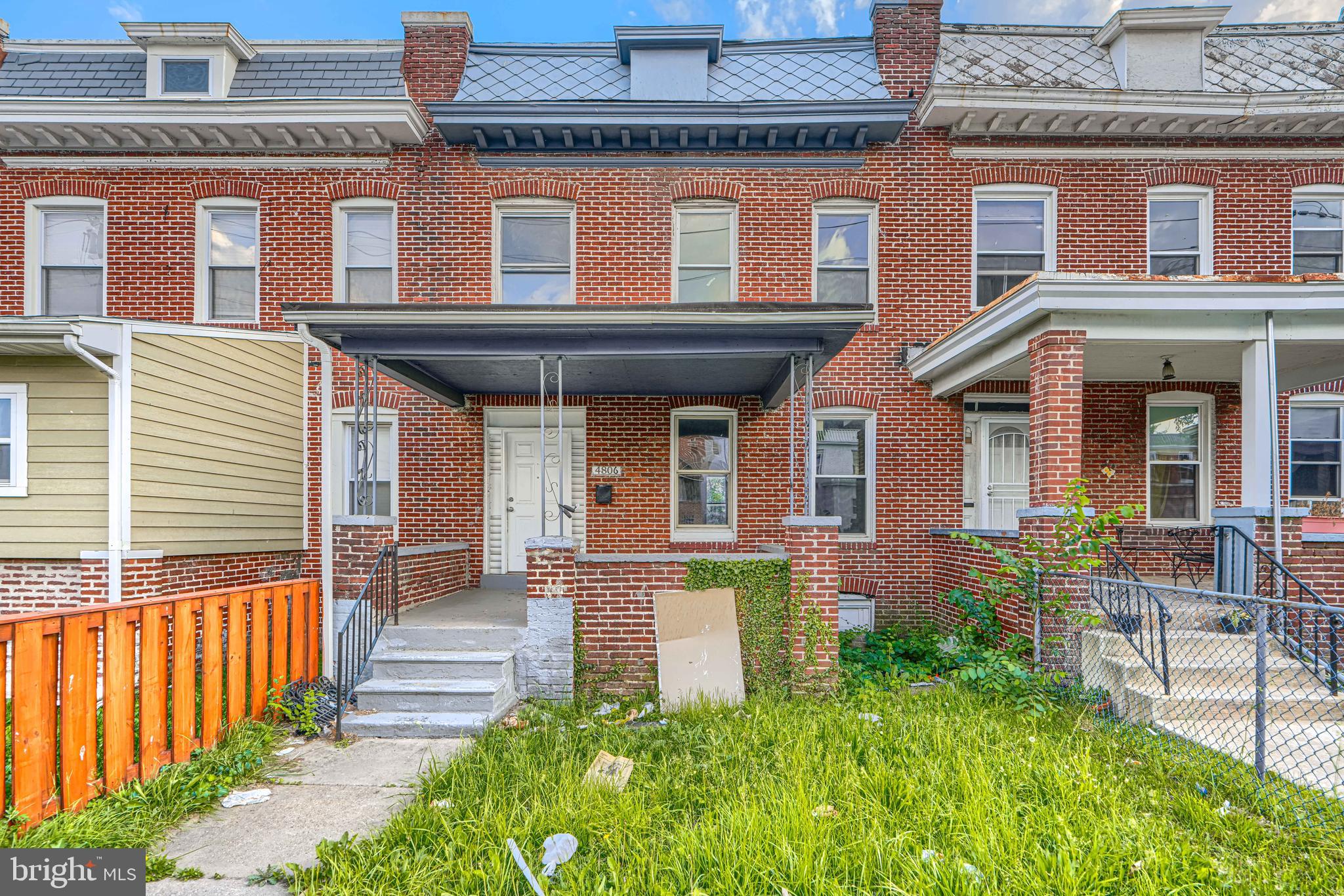 4806 Reisterstown Road Baltimore, MD 21215 - Photo 2 of 34 front view of a brick house with a small yard