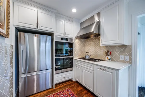 a kitchen with stainless steel appliances granite countertop a refrigerator sink and cabinets