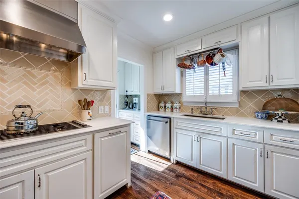 a kitchen with granite countertop white cabinets and white appliances
