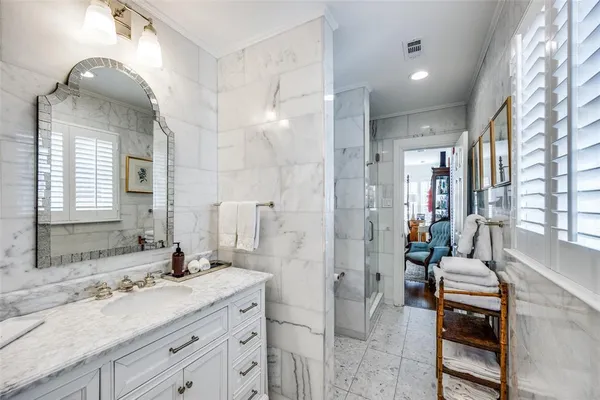 a spacious bathroom with a granite countertop sink mirror and shower