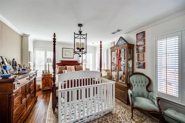 a bedroom with furniture and a large window