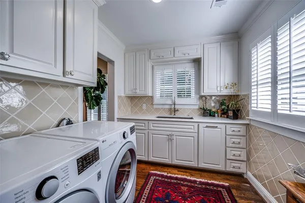a kitchen that has a sink and a stove in it