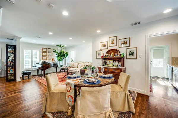 a view of a dining room with furniture wooden floor and next to a window