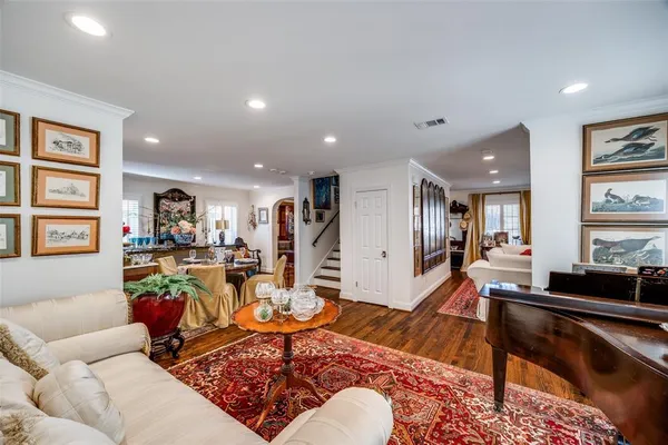 a living room with furniture a wooden floor and a book shelf