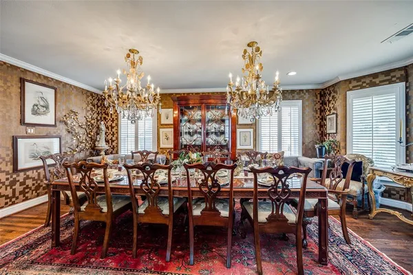 a view of a dining room with furniture wooden floor and chandelier