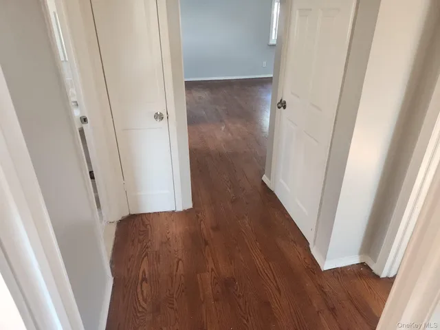 a view of hallway with wooden floor