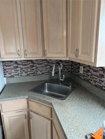 a kitchen with a sink and cabinets