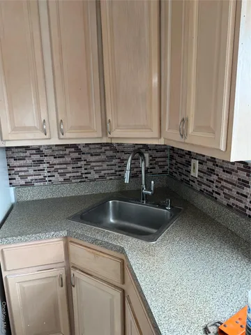 a kitchen with a sink and cabinets