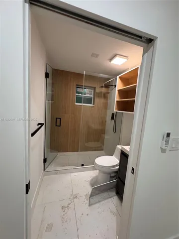 an empty room with wooden floor and closet