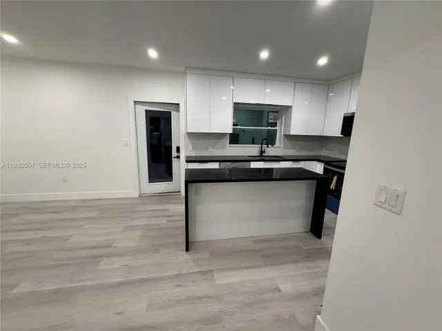 a kitchen with granite countertop a stove and a sink