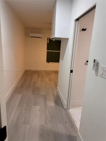 an empty room with closet and a bathroom