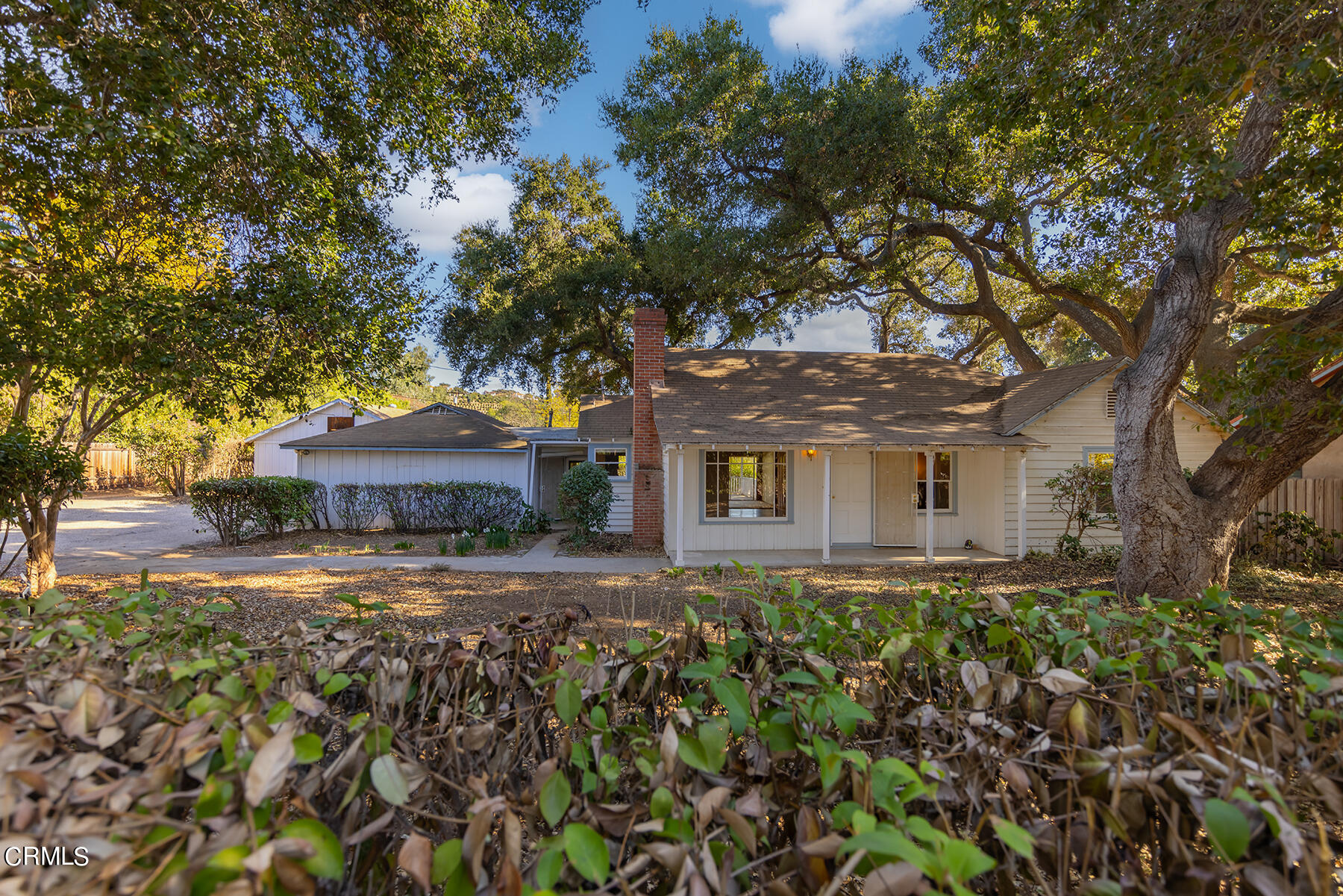 a front view of house with yard and trees