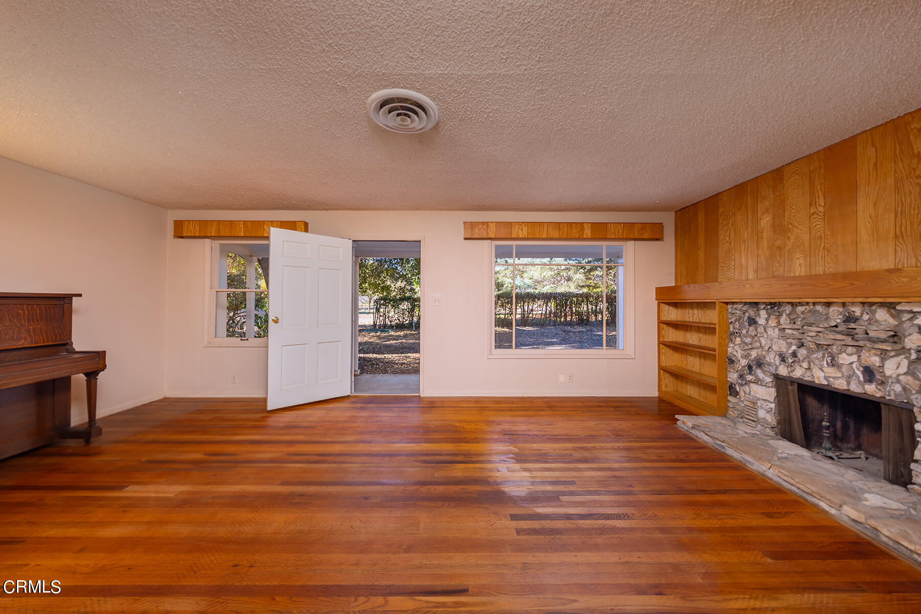 Undisclosed Address Ojai, CA 93023 - Photo 4 of 20 a view of livingroom with hardwood floor and a fireplace