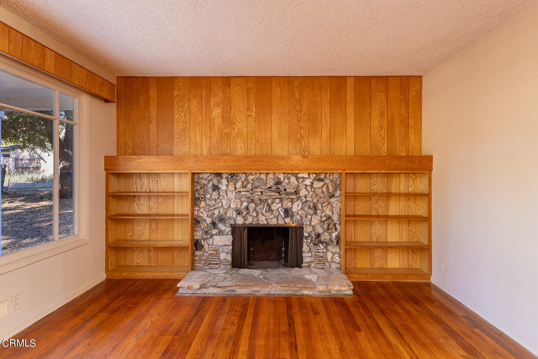 Undisclosed Address Ojai, CA 93023 - Photo 5 of 20 a view of empty room with a fireplace and wooden floor