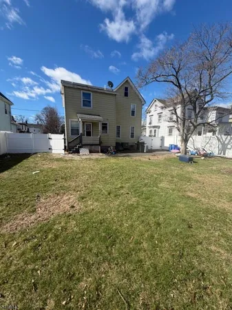 a large house with a big yard and large trees