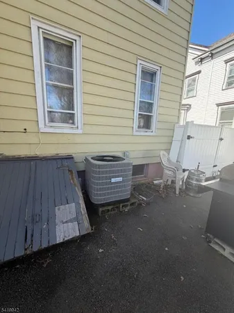 a view of backyard and wooden fence