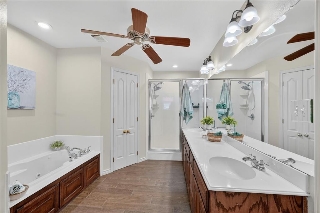 2828 Bennett Road Howe, TX 75459 - Photo 18 of 39 a bathroom with a tub sink and mirror