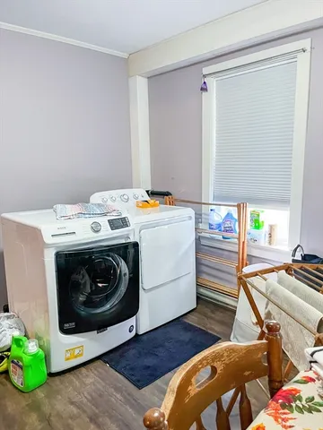 a room with gym equipment and wooden floor