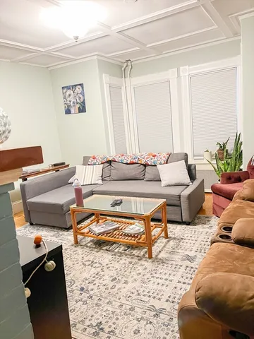 a living room with furniture and a rug