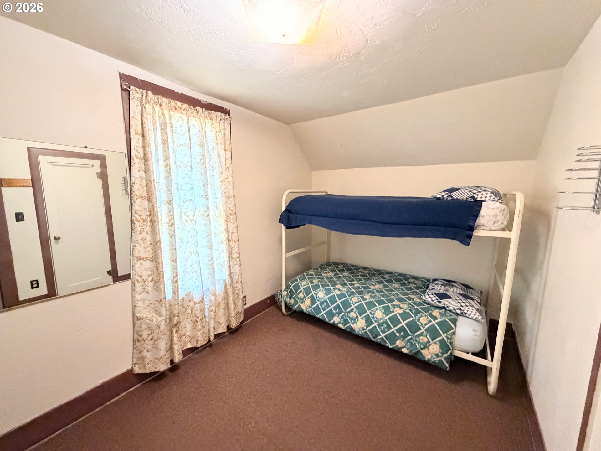 101 Main Street Ukiah, OR 97880 - Photo 11 of 17 a bedroom with a bed and a window