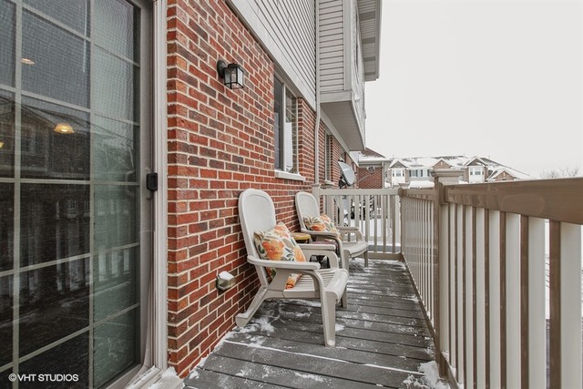 2809 Blakely Lane Naperville, IL 60540 - Photo 15 of 15 a view of a balcony with chair and wooden floor