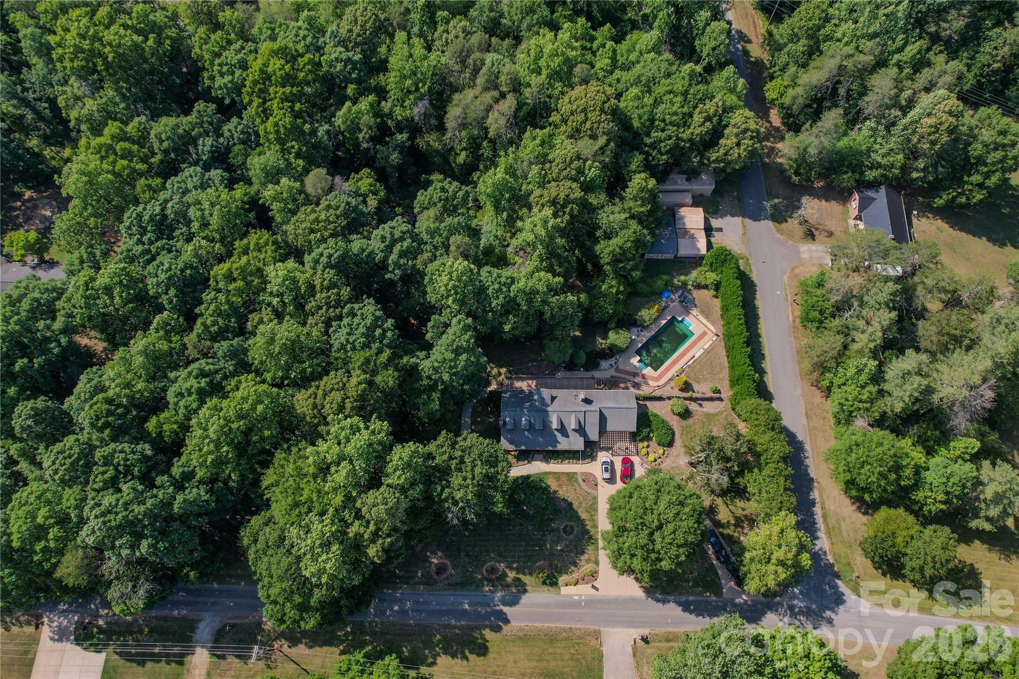 204 Old Stage Coach Road Lawndale, NC 28090 - Photo 10 of 30 an aerial view of a house with outdoor space and trees all around