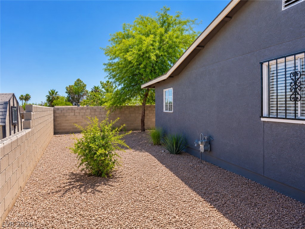 2870 South Sandhill Road Las Vegas, NV 89121 - Photo 12 of 64 A private, low-maintenance yard features mature landscaping and a practical storage shed.