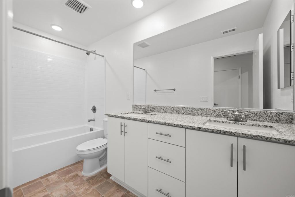 34742 Criollo Way Fallbrook, CA 92028 - Photo 16 of 28 a bathroom with a granite countertop sink a toilet and bathtub