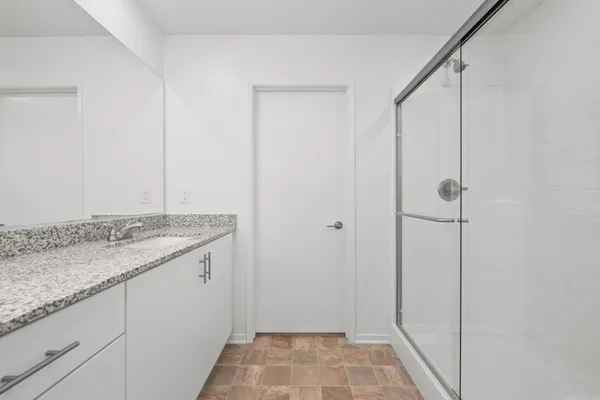 a bathroom with a granite countertop sink and vanity