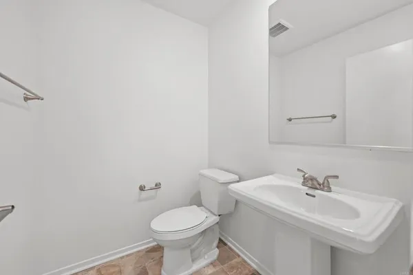 a bathroom with a sink a toilet and mirror